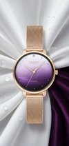 Cassims&Co. Obaku Denmark watch with a purple gradient dial, rose gold mesh strap, and a diamond at 12 o'clock.