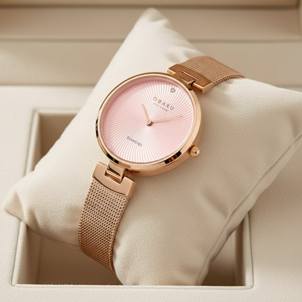 Cassims&Co. Obaku Diamant Peony watch with a pink sunray dial, diamond accent, and rose gold mesh strap in a gift box.