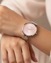 Cassims&Co. Obaku Diamant watch with a pink sunburst dial, diamond accent, and stainless steel mesh strap on a wrist.