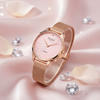 Cassims&Co. Obaku Smykke rose gold watch with a pink sunburst dial, diamond accent, and mesh strap on satin fabric.