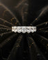Cassims&Co. 9ct white gold seven-stone oval lab grown diamond ring on a black velvet background.