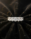 Cassims&Co. 9ct white gold seven-stone oval lab grown diamond ring on a black velvet background.