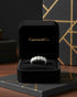 Cassims&Co. seven-stone oval lab grown diamond ring in 9ct white gold displayed in a black velvet jewellery box.