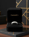 Cassims&Co. seven-stone oval lab grown diamond ring in 9ct white gold displayed in a black velvet jewellery box.