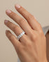 Cassims&Co. 9ct white gold seven-stone oval lab grown diamond ring worn on a woman's finger.