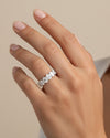 Cassims&Co. 9ct white gold seven-stone oval lab grown diamond ring worn on a woman's finger.