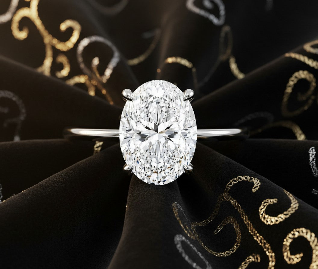 Cassims&Co. 9ct white gold engagement ring featuring a 2ct oval lab grown diamond in a classic four-claw setting.