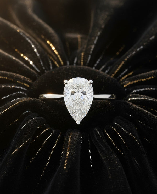Cassims&Co. 9ct white gold engagement ring featuring a 1.58ct pear-shaped lab grown diamond solitaire on black velvet.
