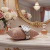 Cassims&Co. TAG Heuer Aquaracer ladies watch with mother-of-pearl dial on a pink velvet cushion on a vanity table.