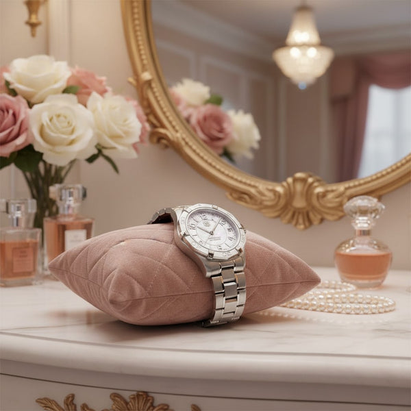 Cassims&Co. TAG Heuer Aquaracer ladies watch with mother-of-pearl dial on a pink velvet cushion on a vanity table.
