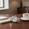 Cassims&Co. TAG Heuer Aquaracer ladies watch with silver dial and stainless steel bracelet on a wooden desk.