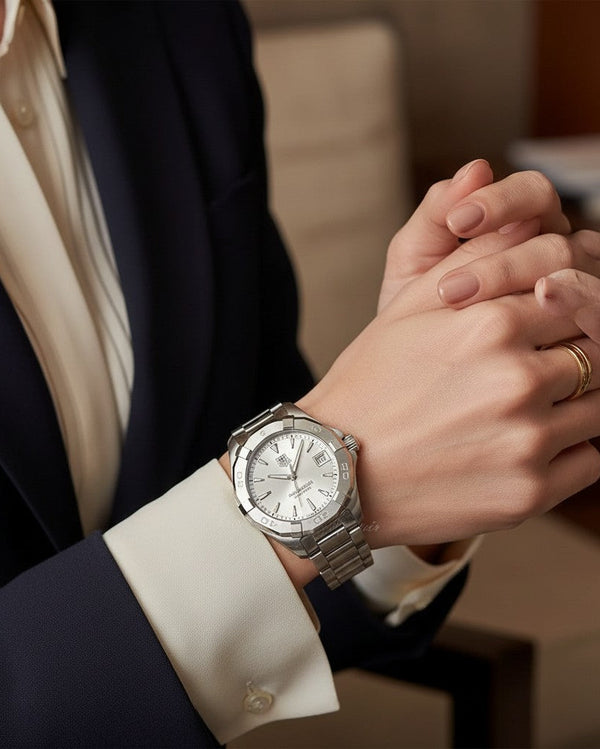 Cassims&Co. TAG Heuer Aquaracer ladies watch with silver sunray dial and stainless steel bracelet on a woman's wrist.