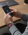Cassims&Co. TAG Heuer Connected Calibre E4 smartwatch with red dial and stainless steel bracelet on a man's wrist