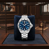 Cassims&Co. pre-owned TAG Heuer Formula 1 watch with a sunray blue dial and stainless steel bracelet in a display case.
