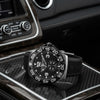 Cassims&Co. pre-owned TAG Heuer Formula 1 Grande Date watch with black dial and rubber strap on a car console