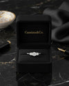 Cassims&Co. 9ct white gold three stone lab grown diamond engagement ring in a black velvet presentation box