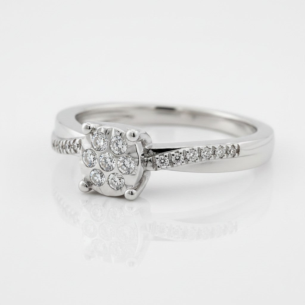 Cassims&Co. 9ct white gold engagement ring featuring a cushion-shaped diamond cluster and pavé diamond shoulders.