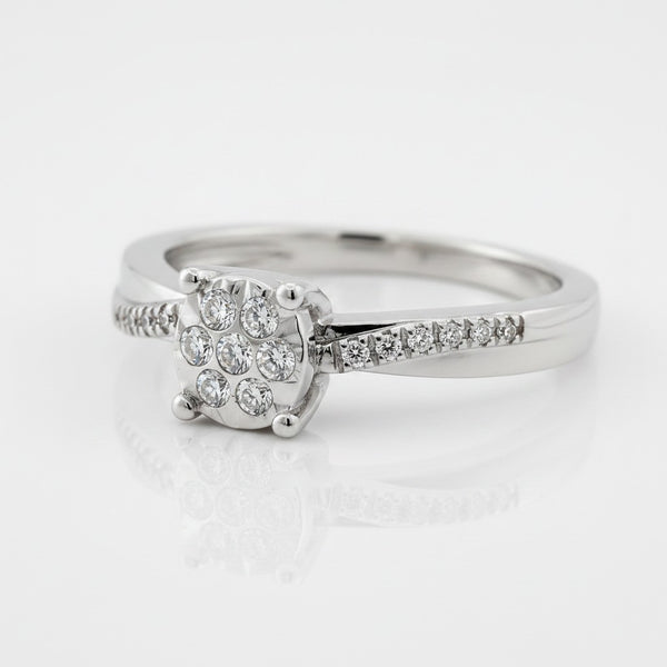Cassims&Co. 9ct white gold engagement ring featuring a cushion-shaped diamond cluster and pavé diamond shoulders.