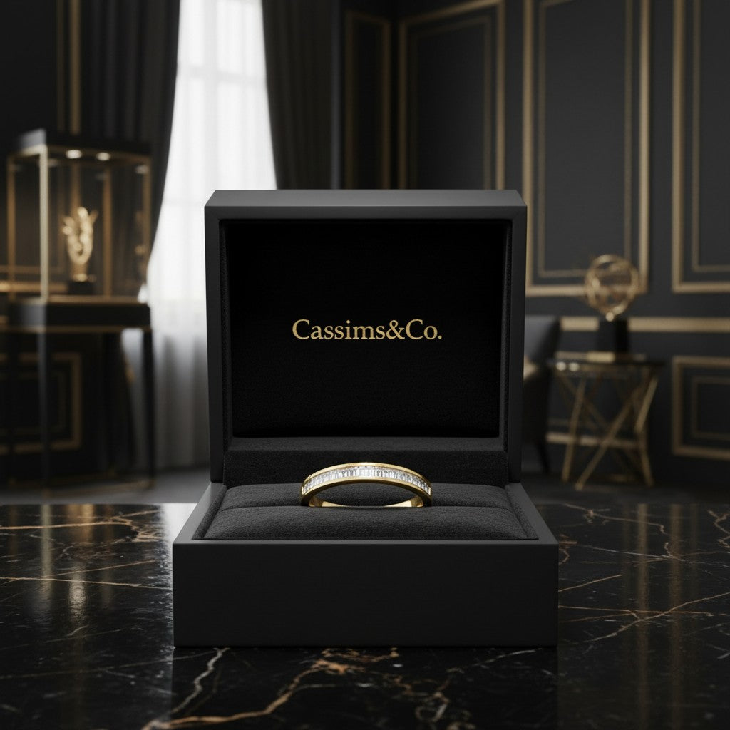 Cassims&Co. 9ct yellow gold band featuring channel-set baguette diamonds displayed in a luxury black jewellery box.