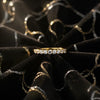 Cassims&Co. 9ct yellow gold eternity ring featuring a row of brilliant lab grown diamonds on black velvet fabric.