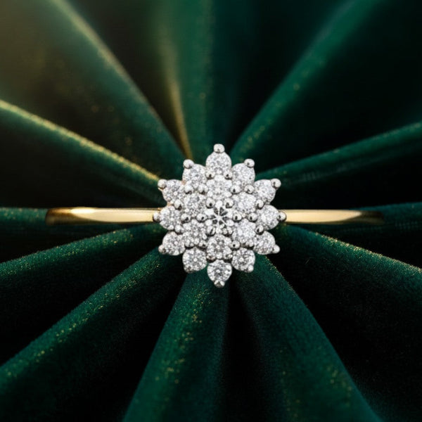 Cassims&Co. 9ct yellow gold diamond flower cluster engagement ring on a dark green velvet background.