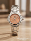 Cassims&Co. pre-owned TAG Heuer Professional ladies watch with a salmon dial, diamond markers, and steel bracelet.