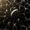 Cassims&Co. 9ct yellow gold band featuring a channel-set row of baguette-cut diamonds on black velvet fabric.