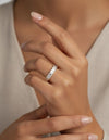 Cassims&Co. 9ct yellow gold eternity band featuring emerald cut lab grown diamonds on a woman's finger