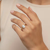 Cassims&Co. 9ct yellow gold engagement ring featuring a 1.00ct emerald-cut lab grown diamond on a woman's finger.