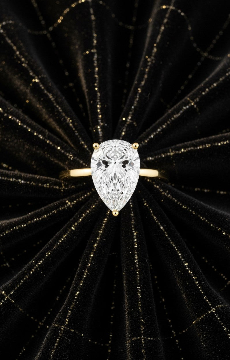 Cassims&Co. 2.00ct pear shape lab grown diamond solitaire engagement ring in 9ct yellow gold on black velvet