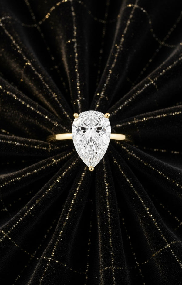 Cassims&Co. 2.00ct pear shape lab grown diamond solitaire engagement ring in 9ct yellow gold on black velvet