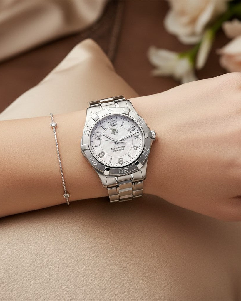 Cassims&Co. TAG Heuer Aquaracer ladies watch with mother-of-pearl dial and stainless steel bracelet on a wrist.