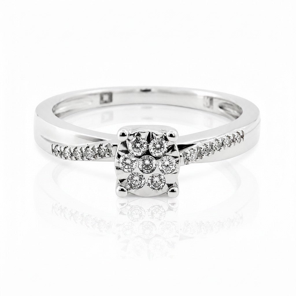 Cassims&Co. 9ct white gold engagement ring featuring a cushion-shaped diamond cluster and pavé diamond shoulders.