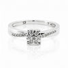 Cassims&Co. 9ct white gold engagement ring featuring a cushion-shaped diamond cluster and pavé diamond shoulders.