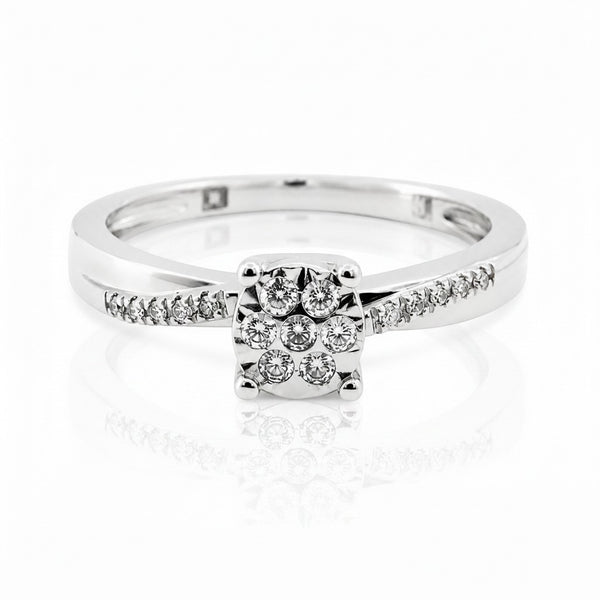 Cassims&Co. 9ct white gold engagement ring featuring a cushion-shaped diamond cluster and pavé diamond shoulders.