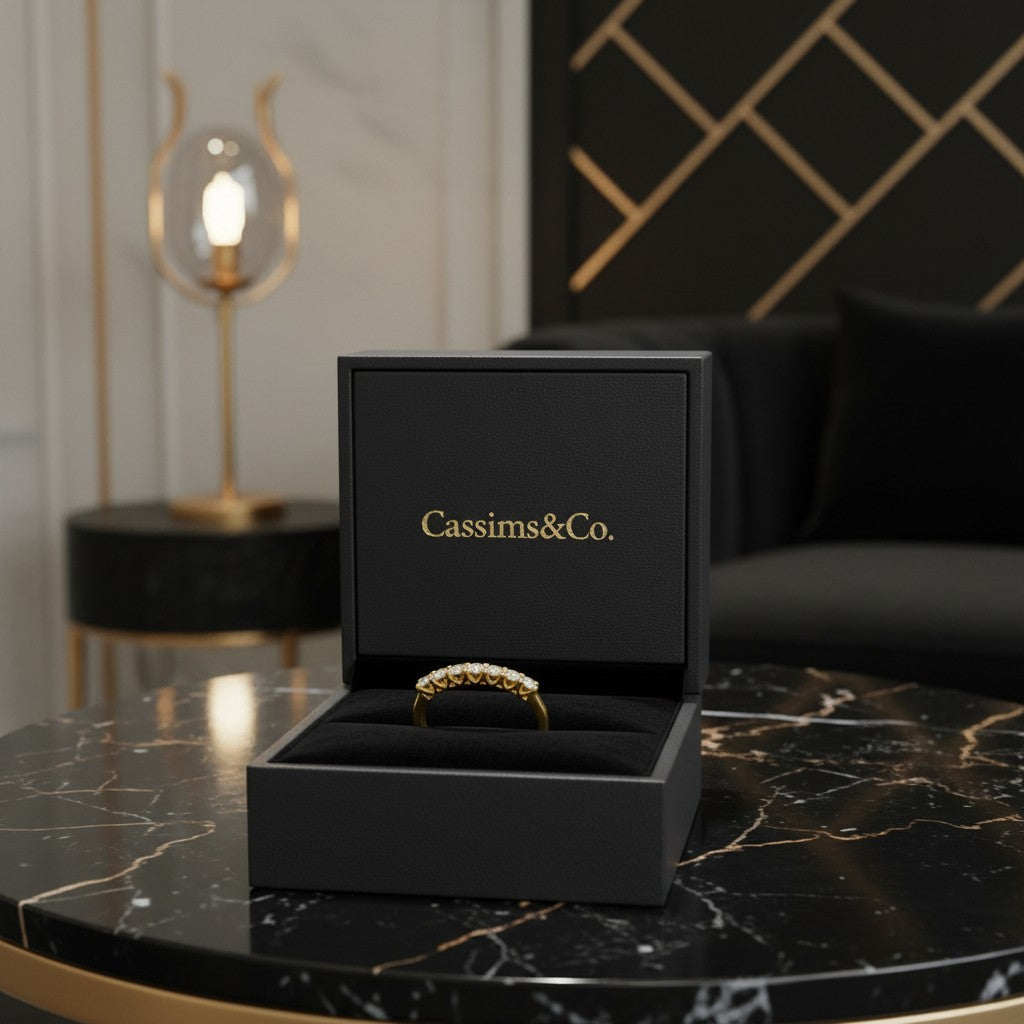 Cassims&Co. 9ct yellow gold eternity ring with lab grown diamonds displayed in a black branded jewellery box.