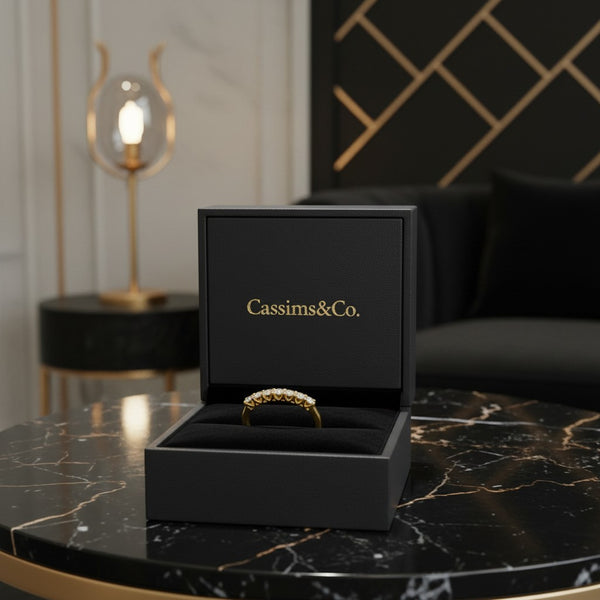 Cassims&Co. 9ct yellow gold eternity ring with lab grown diamonds displayed in a black branded jewellery box.