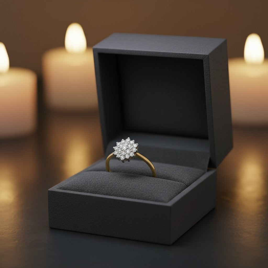 Cassims&Co. 9ct yellow gold diamond flower cluster engagement ring in a dark grey presentation box with candles.