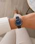 Close view of blue dial, baton indices and rose gold-toned chapter ring