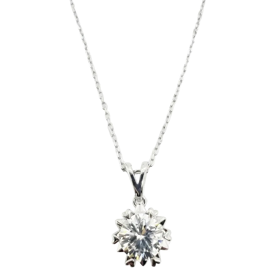 Solitaire pendant with round moissanite in a heart-tipped claw setting on a fine cable chain