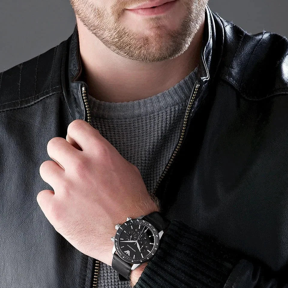 Round 43mm stainless steel case with black tachymeter bezel on leather strap