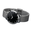 Silver watch with black dial on a dark surface
