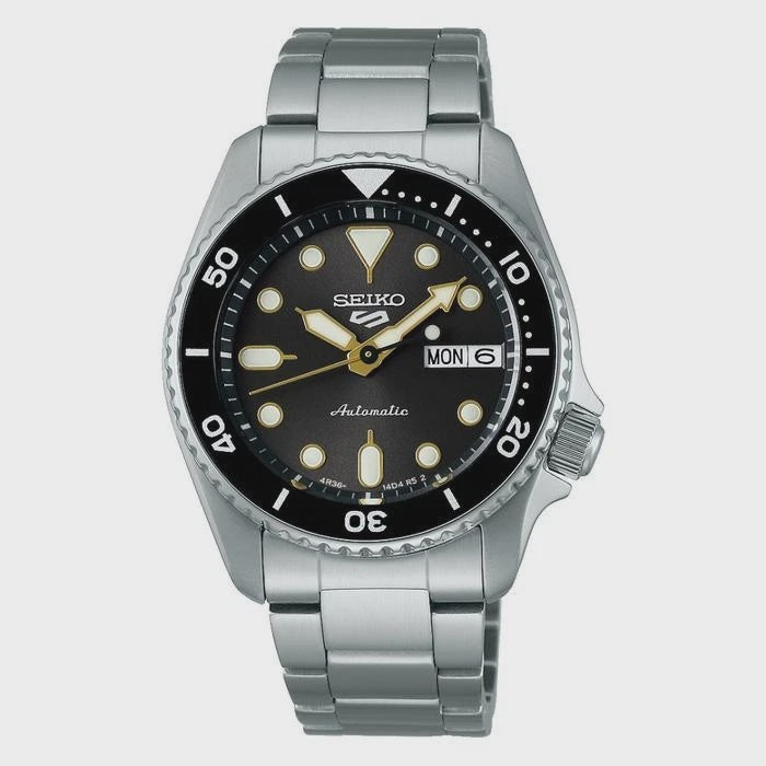 Seiko 5 Sports SRPL79K1 automatic dive watch with black dial, gold-toned hands, stainless steel case and bracelet, unidirectional bezel