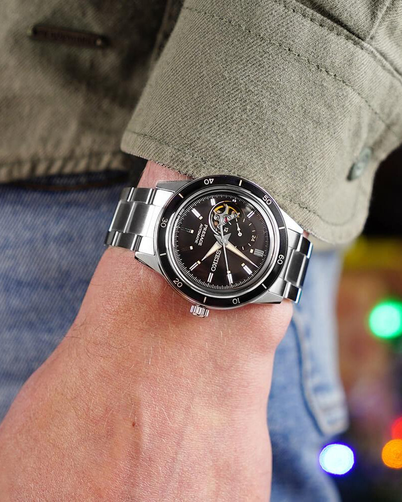 Black open heart dial with 24-hour subdial at 12 o'clock close up