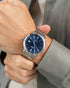 Blue sunburst dial with applied hour markers and date window at 3 o'clock