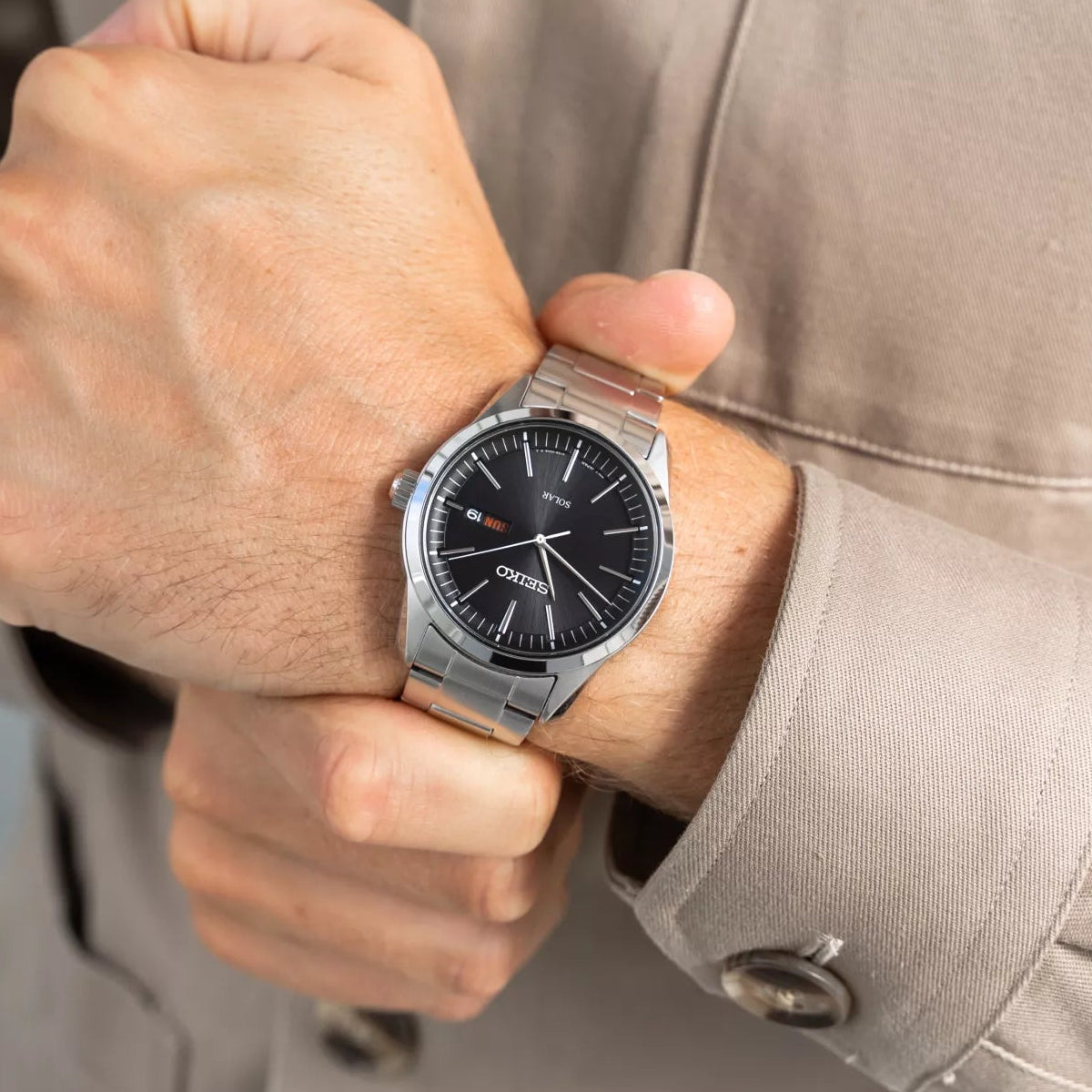 Close view of black dial with applied hour markers and Day-Date display